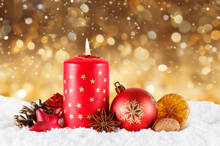 Christmas card advent time with burning candle decoration golden gold background with copyspace copy spaceの写真素材