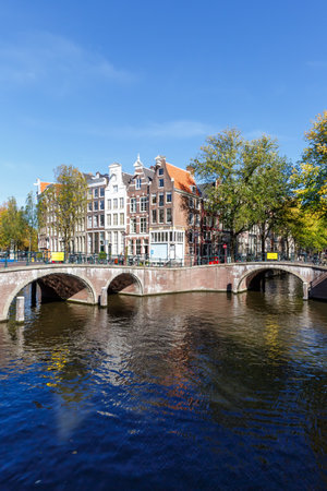 Canal and bridges traditional Dutch houses at Keizersgracht portrait format traveling in Amsterdam, Netherlandsの写真素材