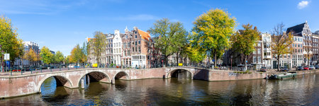 Canal and bridges traditional Dutch houses at Keizersgracht traveling panorama in Amsterdam, Netherlandsの写真素材