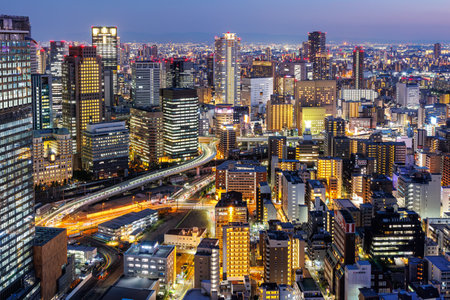 Osaka big city lights from above skyline with skyscraper town at twilight in Japanの写真素材