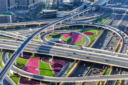 Dubai crossroads of Sheikh Zayed Road highway interchange traffic near Burj Khalifa with metro train