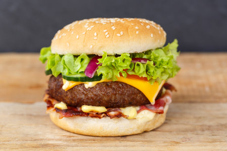 Hamburger cheeseburger fast food on a wooden board snackの写真素材