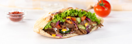 Doner Kebab Doner Kebap fast food in flatbread on a wooden board panoramic snackの写真素材