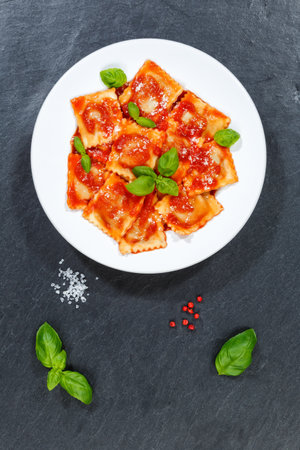Ravioli pasta meal from Italy lunch dish with tomato sauce eat top view on a plate portrait formatの写真素材