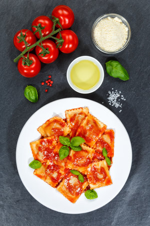 Ravioli pasta meal from Italy eat lunch dish with tomato sauce top view on a plate portrait formatの写真素材