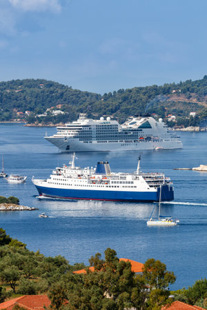Cruise ship, ferry and boats travel portrait format in the Mediterranean Sea Aegean island of Skiathos, Greeceの写真素材