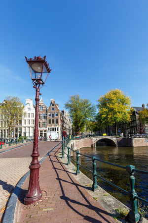 Canal and bridges traditional Dutch houses at Keizersgracht portrait format traveling in Amsterdam, Netherlandsの写真素材
