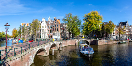 Canal and bridges traditional Dutch houses at Keizersgracht traveling panorama in Amsterdam, Netherlandsの写真素材