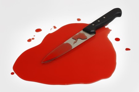 A sharp kitchen knife in a pool of blood. の写真素材
