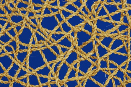 many ropes woven into one another with a blue backgroundの写真素材