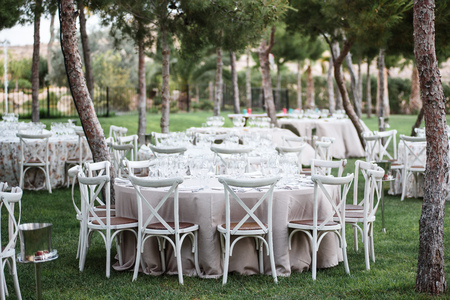 Tables decor in the restaurant on wedding day. Paster decorations, outdoor