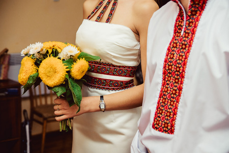 Closeup of Ukrainian groom and bride in embroidered dress and shirtの写真素材