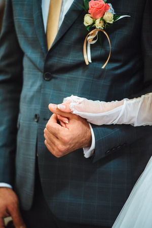 Closeup newly weds are holding each other's handの写真素材