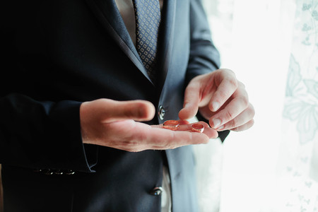 Happy groom with golden wedding rings on his hand. Wedding dayの写真素材