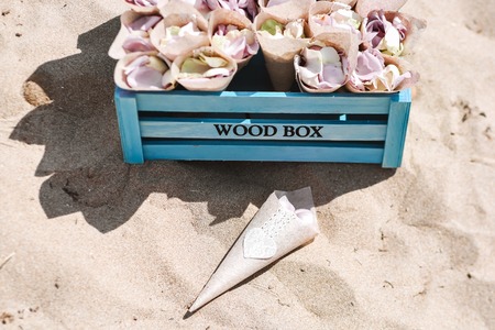 Beach wedding decoration details in front of the sea. Set of hats and begs. Hot sunny summer day.