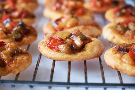 Spanish traditional cocas mini pizzas on white background