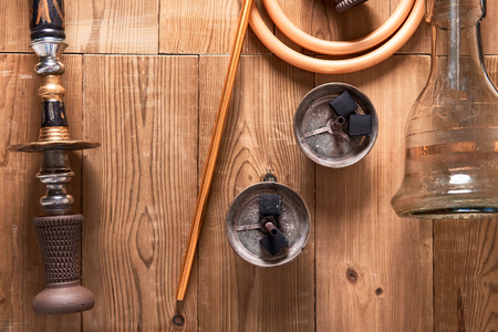 Top view of shisha details on wooden background. Hookah, pipes and coal. Copy space.の写真素材