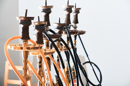 Close-up of eastern hookahs with black pipes on white background. Shisha smoking concept.の写真素材