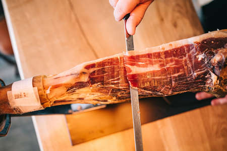 Master slicer cutting iberian cured ham. Selective focus pointの写真素材
