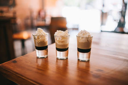 Three layered shots on a bar counter topの写真素材