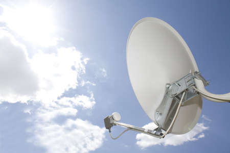 Satellite dish in blue sky の写真素材
