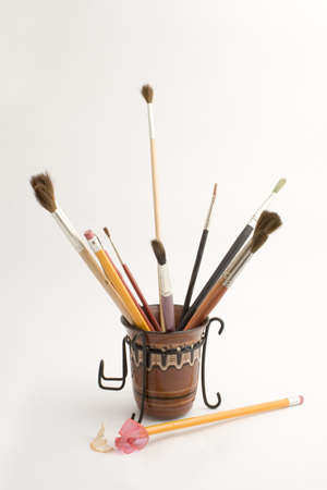many brushes, pencil sharpener and drawingの写真素材