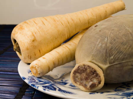 Haggis and Raw Parsnip vegetables on Plateの写真素材