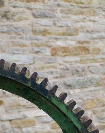 Cross Section of Steel Cog Gear over Brickの写真素材