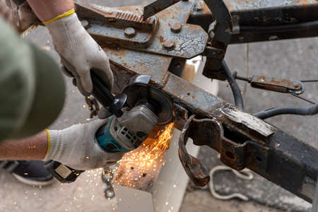 grinding off a piece of metal from a hitchの写真素材