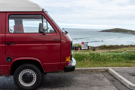 close up of the front of a Red Volkswagen Transporter T3 camping at Fistral Beach , UK ,のeditorial素材