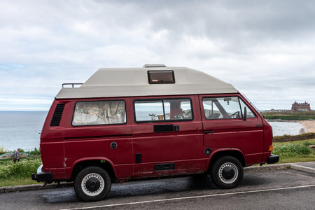 Red Volkswagen Transporter T3 camping at Fistral Beach , UK ,のeditorial素材