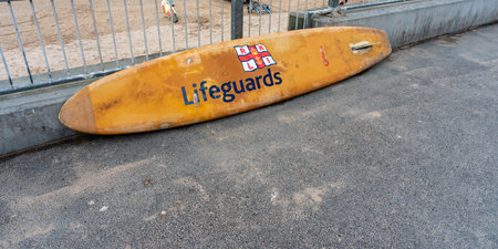 A lifeguard surfboard propped up against the wall ready to go  , Fistral Beach UK ,のeditorial素材