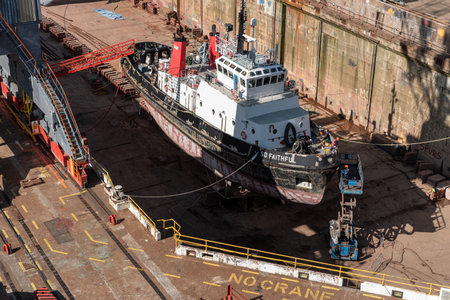 workers fixing a tug boat in a dry dock in Port Falmouth uk , June 12-2022のeditorial素材