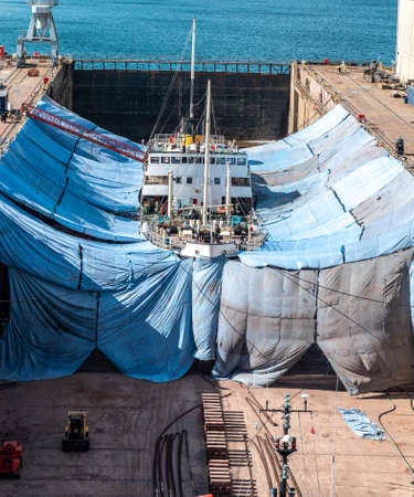 boat undergoing repairs in dry dock at falmouth, cornwallの写真素材