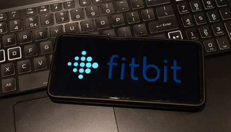 fitbit logo on mobile phone  , background is a keyboard  , Sydney Australia July 30 2022のeditorial素材