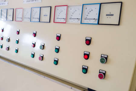 Closeup of industrial control surface with gree and red lit buttons and indicatorsの写真素材
