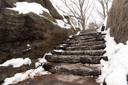 Snow and ice gathered on stone stairs in Central Park, New York Cityの写真素材