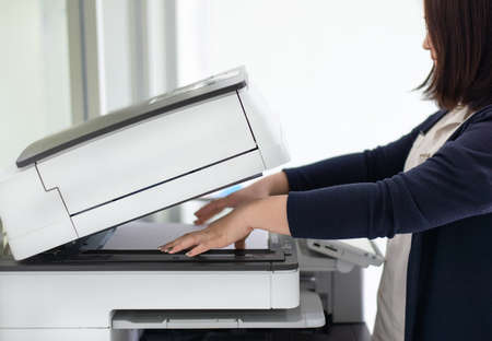 Employees are using photocopiers in the office.の写真素材