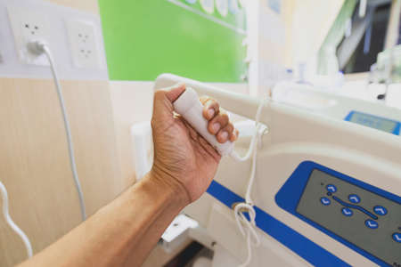 hand pressing emergency nurse call in hospital. Health care and Medical equipment conceptの写真素材