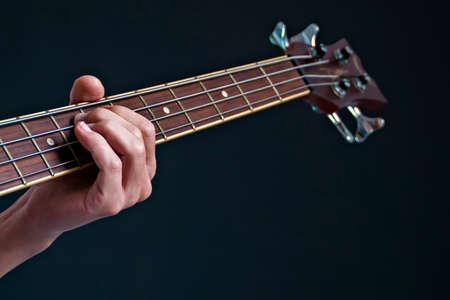 Playing on acoustic bass on a black backgroundの写真素材