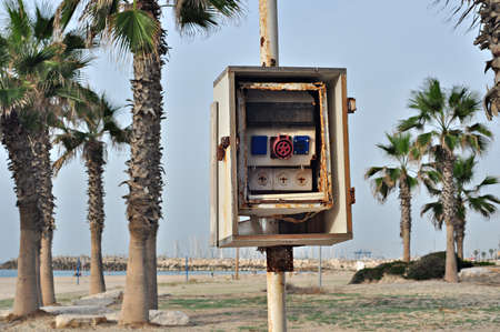 Old broken switchboard on the beachの写真素材