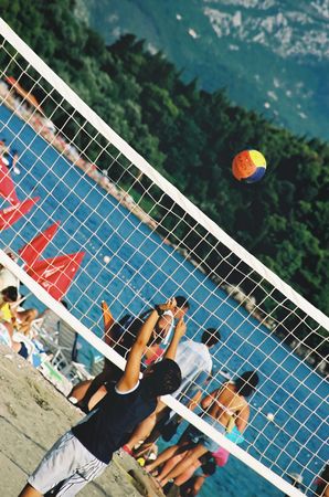 Kid playing valley ball at the beach