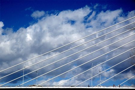 Detail of modern designed bridge with nice clouds above.