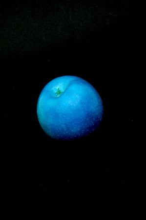 Abstract blue apple on black background.の写真素材