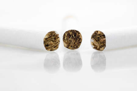 Three cigarets view on top side.White background.の写真素材