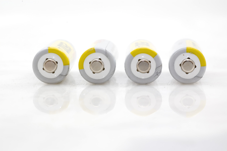 Four AA batteries on white background.