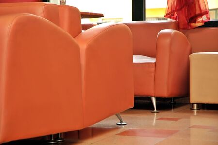 Interior of modern restaurant. Orange leather and luxury chairs.の写真素材