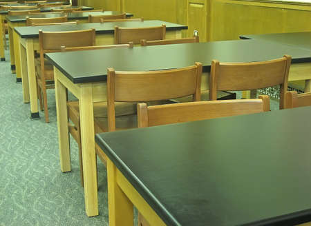 Old-fashioned desks and chairs in school.