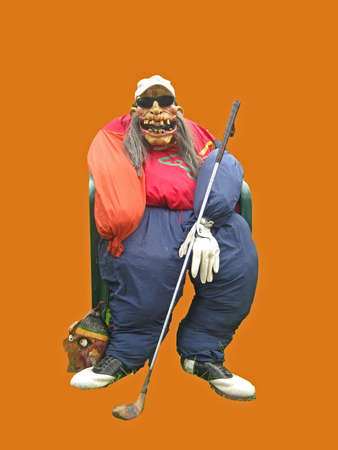 Scary golfer scarecrow on an orange background.の写真素材