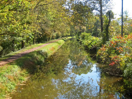 Rural canal in autumn.の写真素材